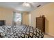 Bright bedroom with double bed, ceiling fan, and ample closet space at 299 W Hickory Ave, Oak Hill, FL 32759