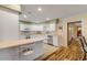 Kitchen with white cabinets, tile floors, and a breakfast bar at 299 W Hickory Ave, Oak Hill, FL 32759