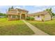 Two story home with a brick facade and walkway at 299 W Hickory Ave, Oak Hill, FL 32759