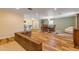 Spacious living room with hardwood floors, a brick wall feature and neutral tones at 299 W Hickory Ave, Oak Hill, FL 32759