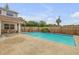Inviting pool area with patio and fenced backyard at 299 W Hickory Ave, Oak Hill, FL 32759