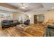 Spacious living room with hardwood floors, leather furniture, and a fireplace at 299 W Hickory Ave, Oak Hill, FL 32759