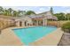 Clean rectangular pool with a wooden fence and shed at 299 W Hickory Ave, Oak Hill, FL 32759