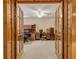 View of home office through wooden french doors at 299 W Hickory Ave, Oak Hill, FL 32759