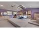 Spacious main bedroom with high ceilings and a large bed at 299 W Hickory Ave, Oak Hill, FL 32759