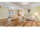 Light and airy living room with hardwood floors and neutral furniture at 299 W Hickory Ave, Oak Hill, FL 32759