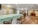 Spacious dining area with wood flooring and view of kitchen at 299 W Hickory Ave, Oak Hill, FL 32759