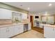 Kitchen with stainless steel appliances, breakfast bar, and view into living area at 299 W Hickory Ave, Oak Hill, FL 32759