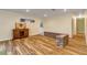 Living room with hardwood floors, brick accent wall, and built-in cabinet at 299 W Hickory Ave, Oak Hill, FL 32759