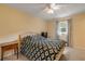 Cozy bedroom with double bed, ceiling fan, and window with curtains at 299 W Hickory Ave, Oak Hill, FL 32759