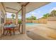 Inviting pool area with patio furniture and covered seating at 299 W Hickory Ave, Oak Hill, FL 32759