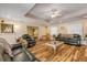 Bright living room featuring hardwood floors and ample seating at 299 W Hickory Ave, Oak Hill, FL 32759