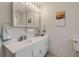 Bright bathroom with double vanity and updated light fixtures at 299 W Hickory Ave, Oak Hill, FL 32759