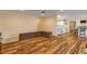 Open living area with hardwood floors and a view of the kitchen at 299 W Hickory Ave, Oak Hill, FL 32759