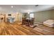 Spacious dining area with hardwood floors, a rug, and a comfortable seating area at 299 W Hickory Ave, Oak Hill, FL 32759