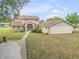 Two story home with a pool and detached garage at 299 W Hickory Ave, Oak Hill, FL 32759