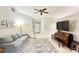 Bright and airy living room featuring comfortable seating and large TV at 790 Pine Shores Cir, New Smyrna Beach, FL 32168