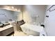 Updated bathroom with soaking tub and pebble tile accents at 790 Pine Shores Cir, New Smyrna Beach, FL 32168
