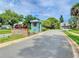 Community entrance with signage and flag at 790 Pine Shores Cir, New Smyrna Beach, FL 32168