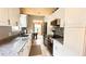 Bright kitchen featuring granite countertops and stainless steel appliances at 790 Pine Shores Cir, New Smyrna Beach, FL 32168