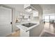 Modern kitchen with white cabinets, quartz countertops, and stainless steel appliances at 2401 S Atlantic Ave # D304, New Smyrna Beach, FL 32169