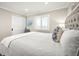 King bed with white bedding in bright bedroom at 2401 S Atlantic Ave # D304, New Smyrna Beach, FL 32169