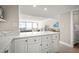 Modern kitchen with white cabinets, quartz countertops, and stainless steel appliances at 2401 S Atlantic Ave # D304, New Smyrna Beach, FL 32169