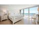 Bright bedroom with white furniture and ocean view at 2401 S Atlantic Ave # D304, New Smyrna Beach, FL 32169