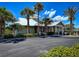Community clubhouse with palm trees at 2401 S Atlantic Ave # D304, New Smyrna Beach, FL 32169