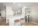 Modern kitchen with white cabinets and breakfast bar at 2401 S Atlantic Ave # D304, New Smyrna Beach, FL 32169