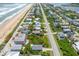 Aerial view of beachfront property with vacant lot and nearby homes at 6368 S Atlantic Ave, New Smyrna Beach, FL 32169