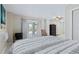 Bedroom with sliding glass doors leading to a patio, offering an ocean view at 6368 S Atlantic Ave, New Smyrna Beach, FL 32169