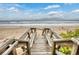 Wooden staircase leading to the beach at 6368 S Atlantic Ave, New Smyrna Beach, FL 32169