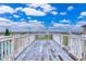 Deck overlooking neighborhood, ocean and blue sky at 6368 S Atlantic Ave, New Smyrna Beach, FL 32169