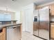 Kitchen features stainless steel appliances and wood cabinets at 521 Mount Olympus Blvd, New Smyrna Beach, FL 32168