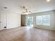 Gathering room with sliding glass doors leading to the backyard at 521 Mount Olympus Blvd, New Smyrna Beach, FL 32168