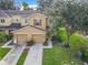 Two-story townhome with two-car garage and front yard at 521 Mount Olympus Blvd, New Smyrna Beach, FL 32168