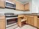 Kitchen with stainless steel appliances and light wood cabinets at 521 Mount Olympus Blvd, New Smyrna Beach, FL 32168