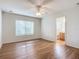 Bedroom with wood floors, a window, and en-suite bathroom access at 521 Mount Olympus Blvd, New Smyrna Beach, FL 32168