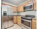 Stainless steel appliances and light wood cabinets in this kitchen at 521 Mount Olympus Blvd, New Smyrna Beach, FL 32168
