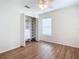 Bright bedroom with wood floors and built-in shelving at 521 Mount Olympus Blvd, New Smyrna Beach, FL 32168