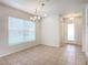 Bright dining room with large window and tile floor at 521 Mount Olympus Blvd, New Smyrna Beach, FL 32168