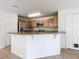 Modern kitchen with stainless steel appliances and light wood cabinets at 521 Mount Olympus Blvd, New Smyrna Beach, FL 32168