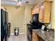 Kitchen with black appliances and wood cabinets at 1600 Big Tree Rd # I-7, Daytona Beach, FL 32119