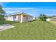 Charming house exterior, showcasing a large backyard and patio at 51 Sun Dunes Cir, Ponce Inlet, FL 32127