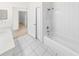 Clean bathroom with bathtub, shower, and white tile at 51 Sun Dunes Cir, Ponce Inlet, FL 32127