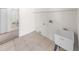Bright laundry room with a sink and access to a bathroom at 51 Sun Dunes Cir, Ponce Inlet, FL 32127