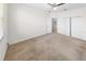 Bright bedroom featuring carpet, window, and double doors to bathroom at 51 Sun Dunes Cir, Ponce Inlet, FL 32127