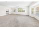 Spacious living room with neutral carpet and large windows at 51 Sun Dunes Cir, Ponce Inlet, FL 32127