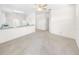 Living area features neutral carpeting and kitchen access at 51 Sun Dunes Cir, Ponce Inlet, FL 32127